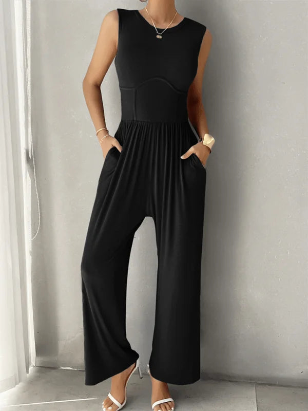 Sleek black sleeveless jumpsuit with a corset-like bodice and wide-leg pants, worn by a model.