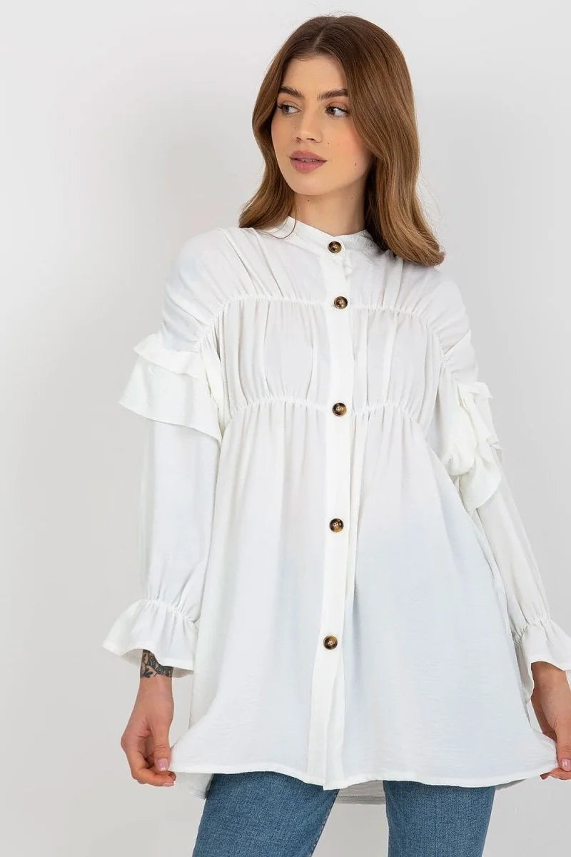 Loose white polyester tunic with ruffled sleeves and button-front detail on model.
