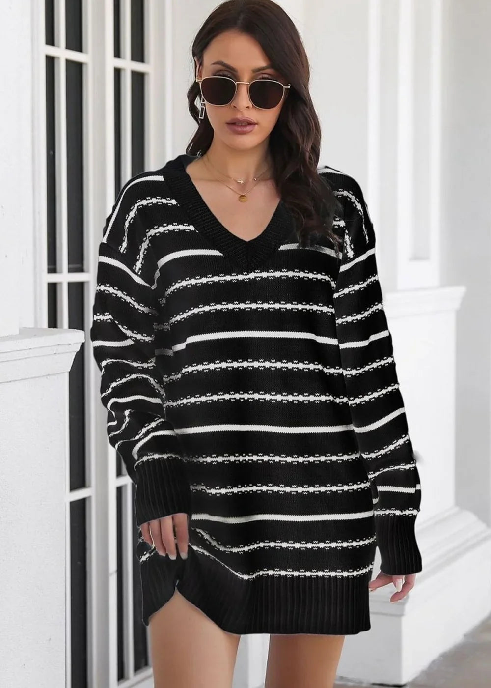 Black and white striped V-neck sweater dress with a regular fit, shown on a model.