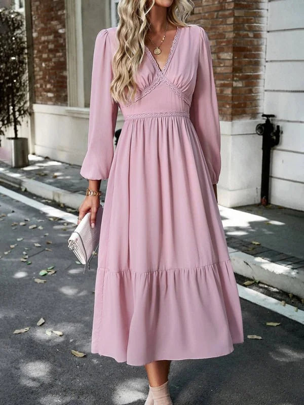 Dusty rose V-neck midi dress with lace trim and tiered skirt, on model.