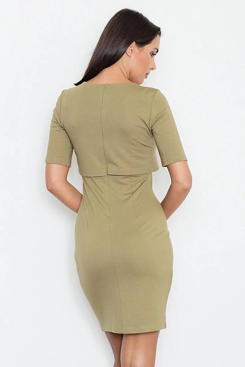 Back view of a woman wearing a fitted olive green midi dress with a cropped overlay.