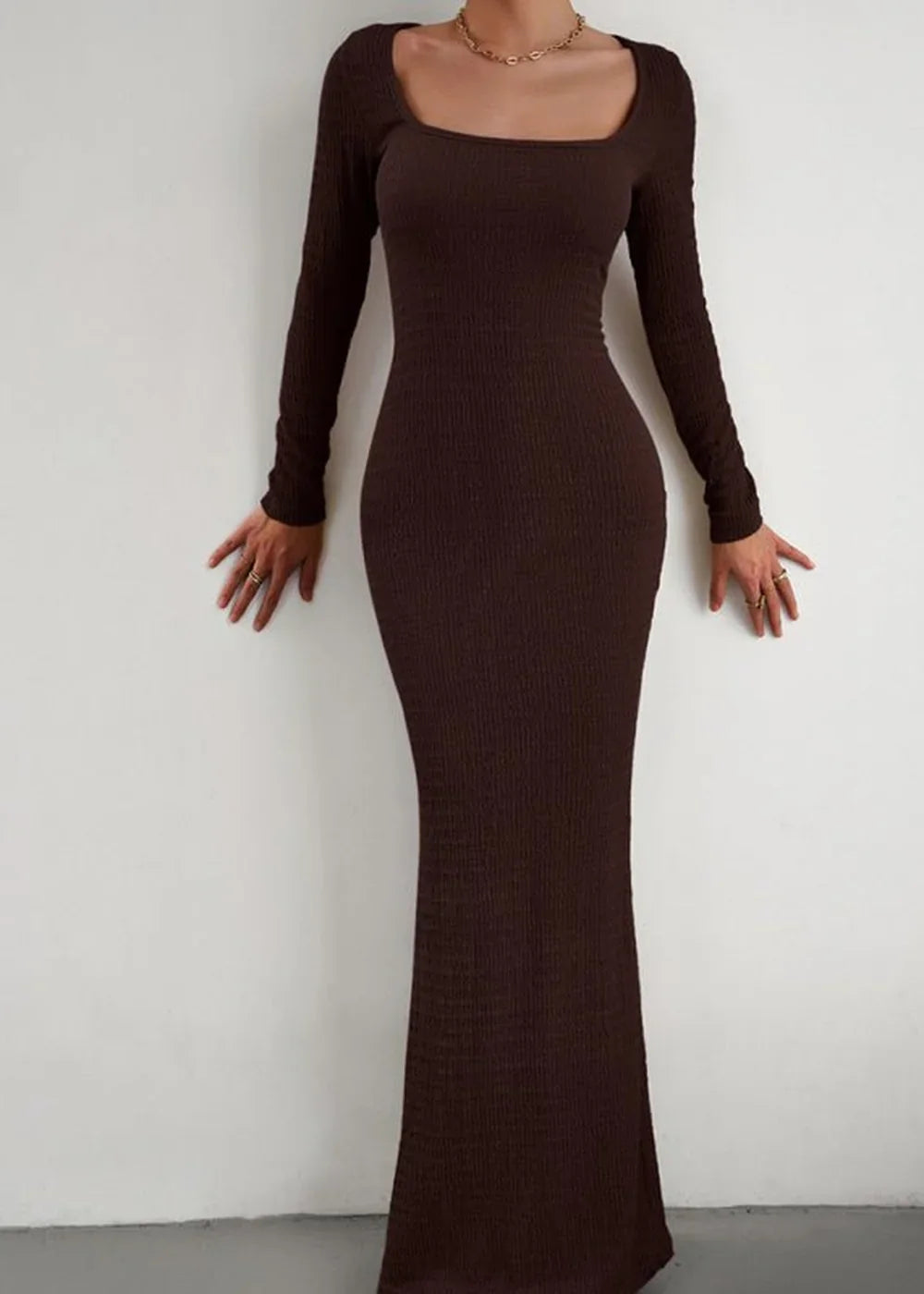 Brown ribbed knit maxi dress with square neckline and long sleeves, fitted silhouette.