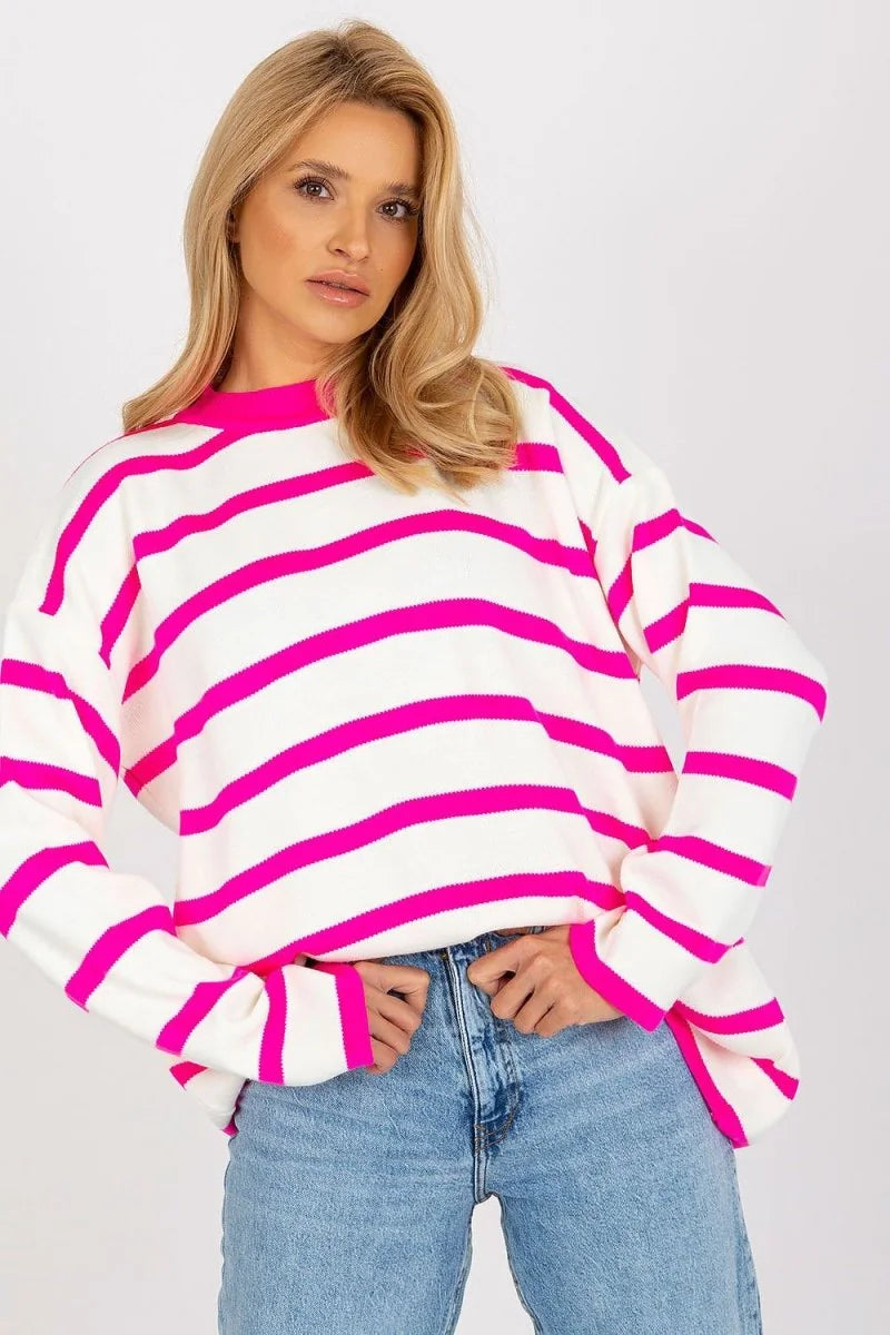 Relaxed fit white sweater with bold hot pink horizontal stripes and long sleeves on a model.