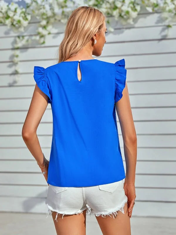 Blue ruffled short-sleeve top with keyhole back, paired with white denim shorts.