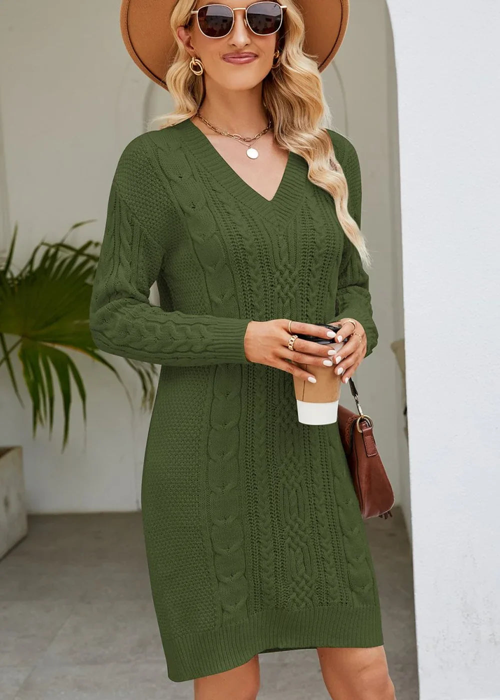 Olive green cable knit V-neck sweater dress on model, with a brown crossbody bag.