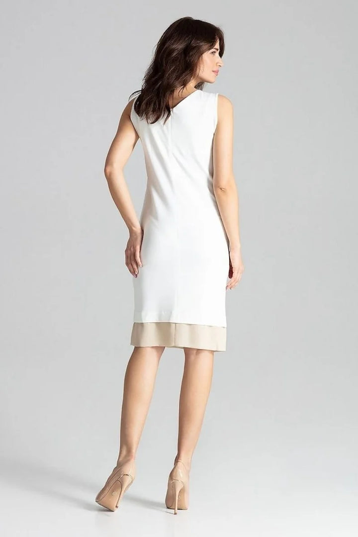 Sleeveless white dress with beige trim, regular fit, on model.
