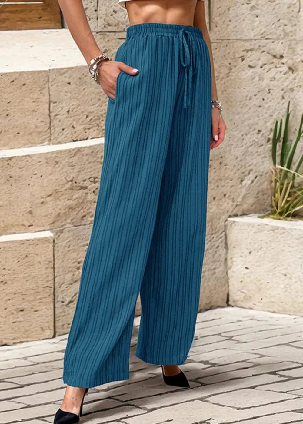 Teal textured wide-leg pants with drawstring waist and pockets on model