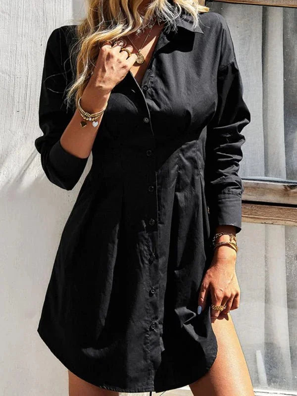Black cotton-blend shirt dress with button-down front and long sleeves, worn by a model.