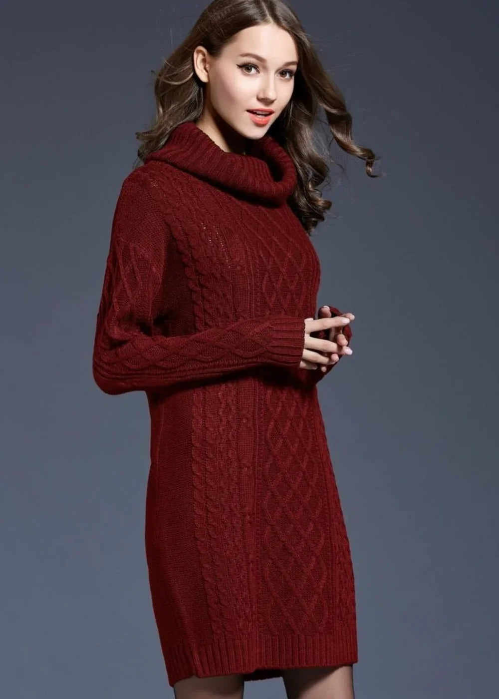 Wine-colored cable knit turtleneck sweater dress with long sleeves on a model.