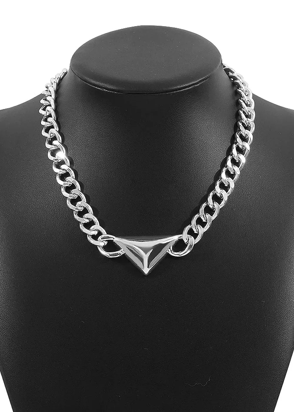 Silver chain necklace with a geometric triangle pendant on a black bust.
