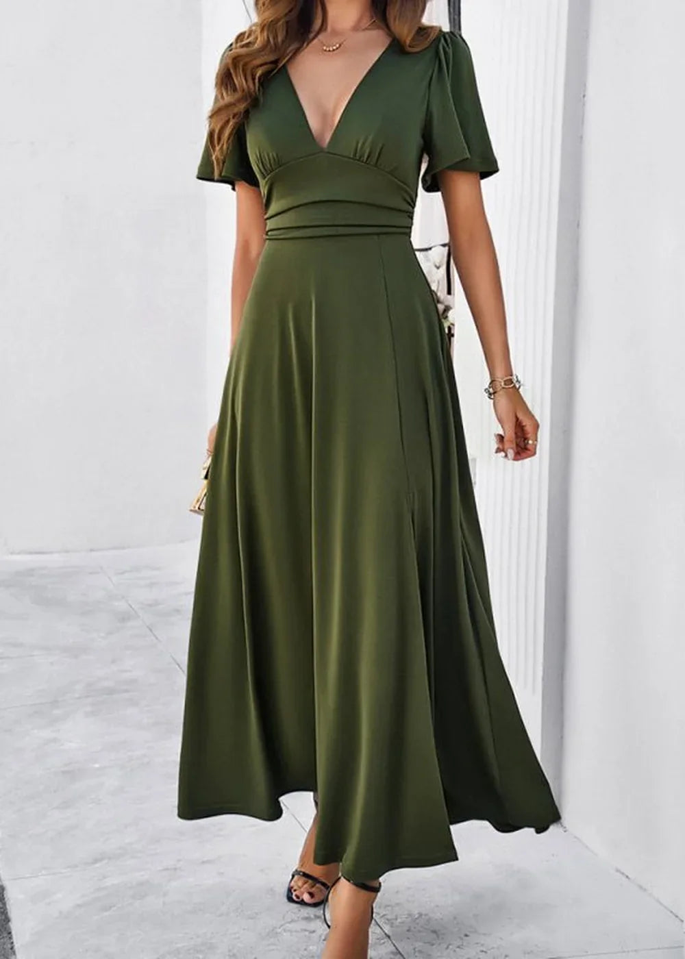 Olive green maxi dress with V-neck, flutter sleeves, and a flowy skirt on a model.