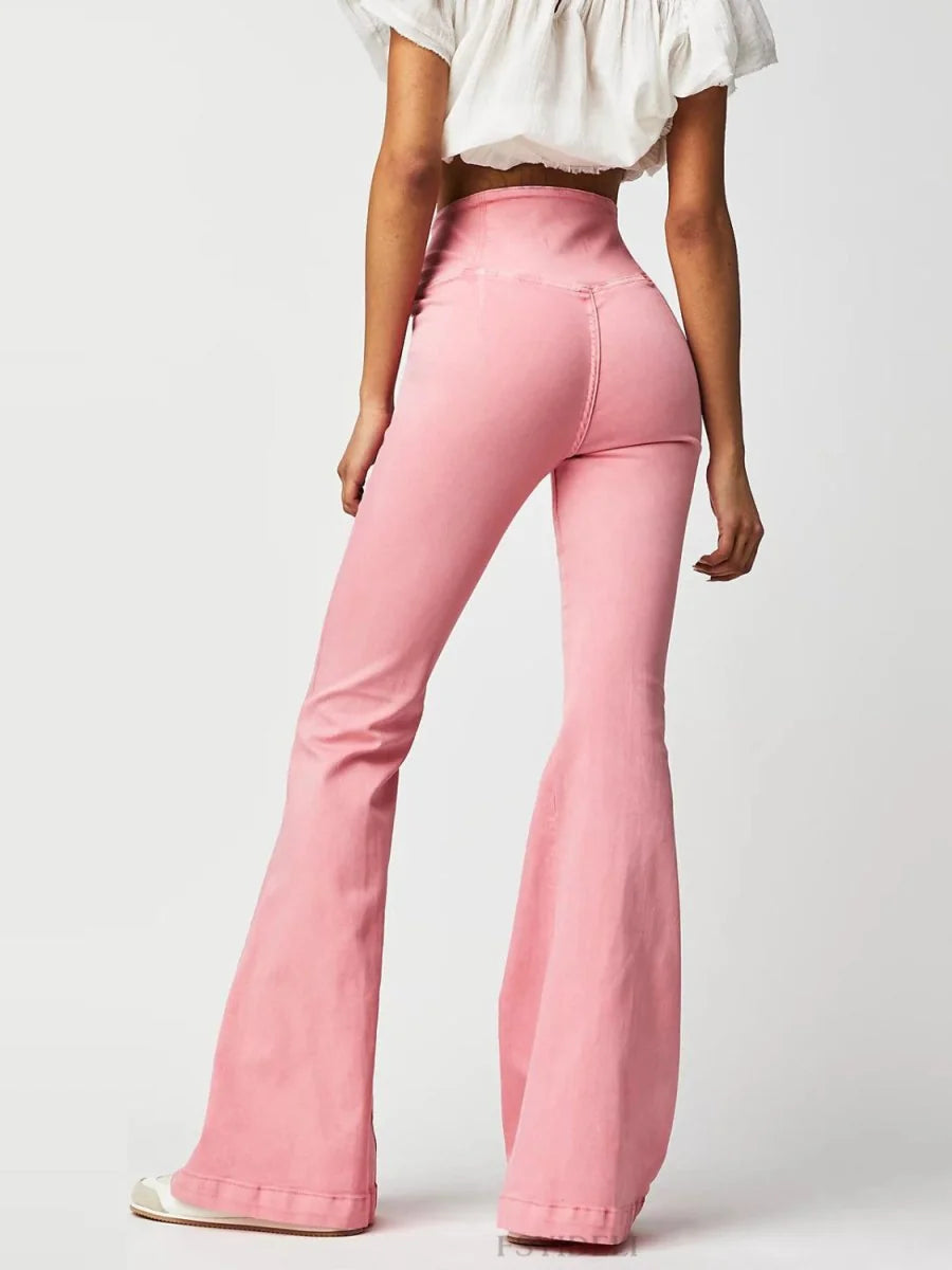 Watermelon pink high-waisted flare jeans with a fitted silhouette and wide leg opening, shown from the back.