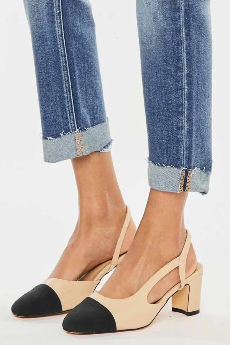 Beige and black color-block slingback heels with a block heel and distressed denim jeans with cuffed hems.