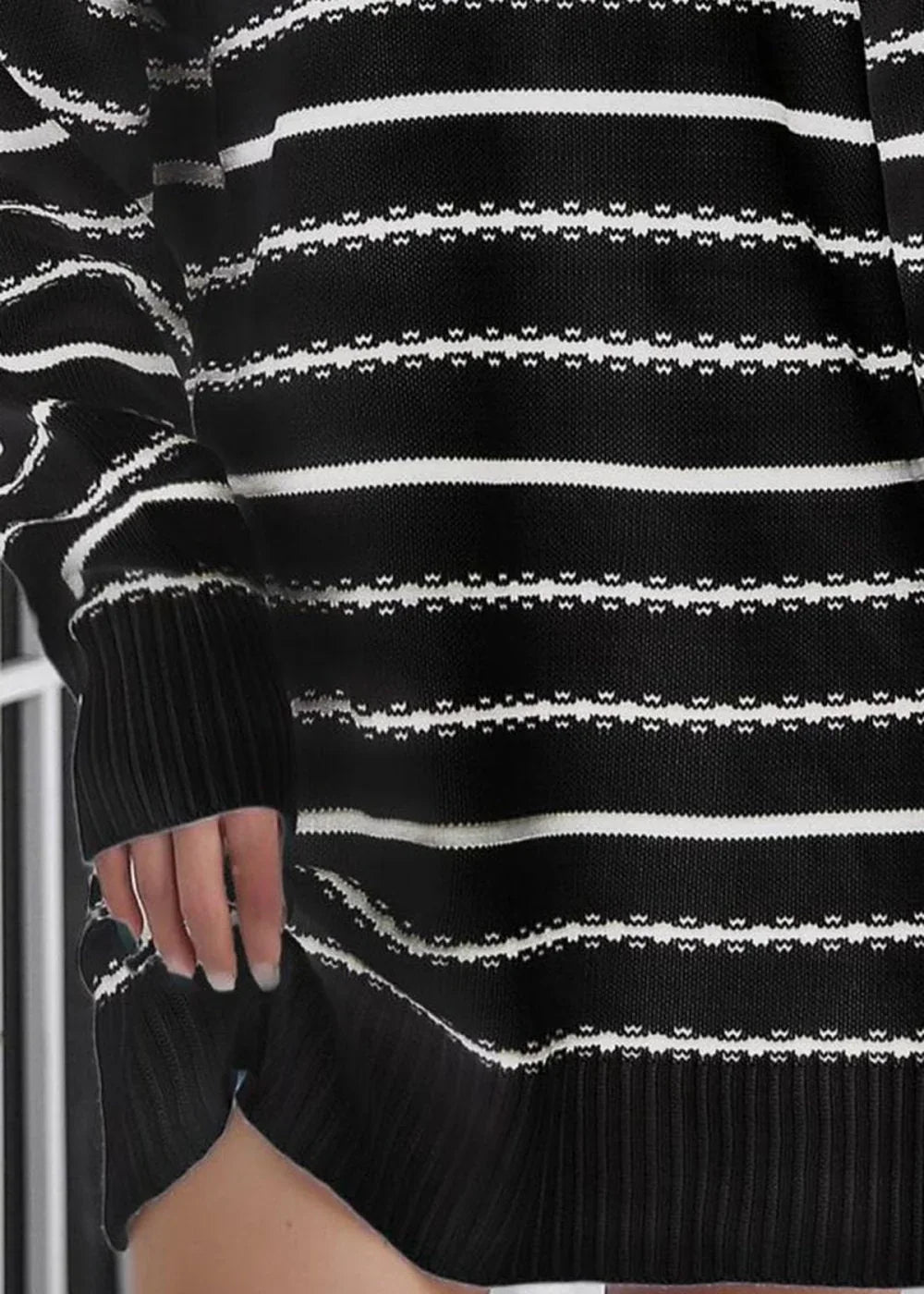 Black and white striped knit sweater dress with ribbed cuffs and hem.