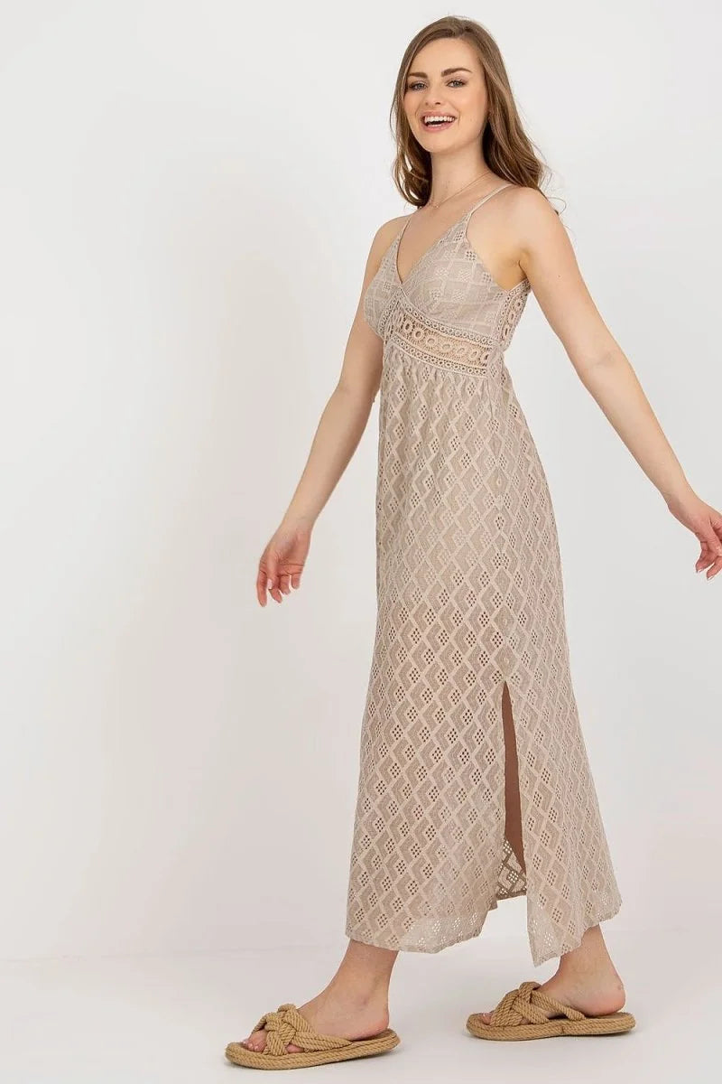 Beige lace maxi dress with V-neck and side slit, worn with braided sandals.