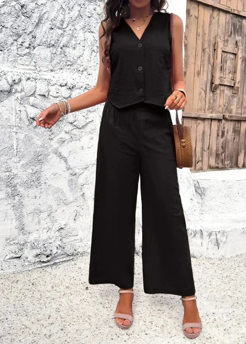 Black linen blend wide-leg pants and sleeveless button-up top on model.