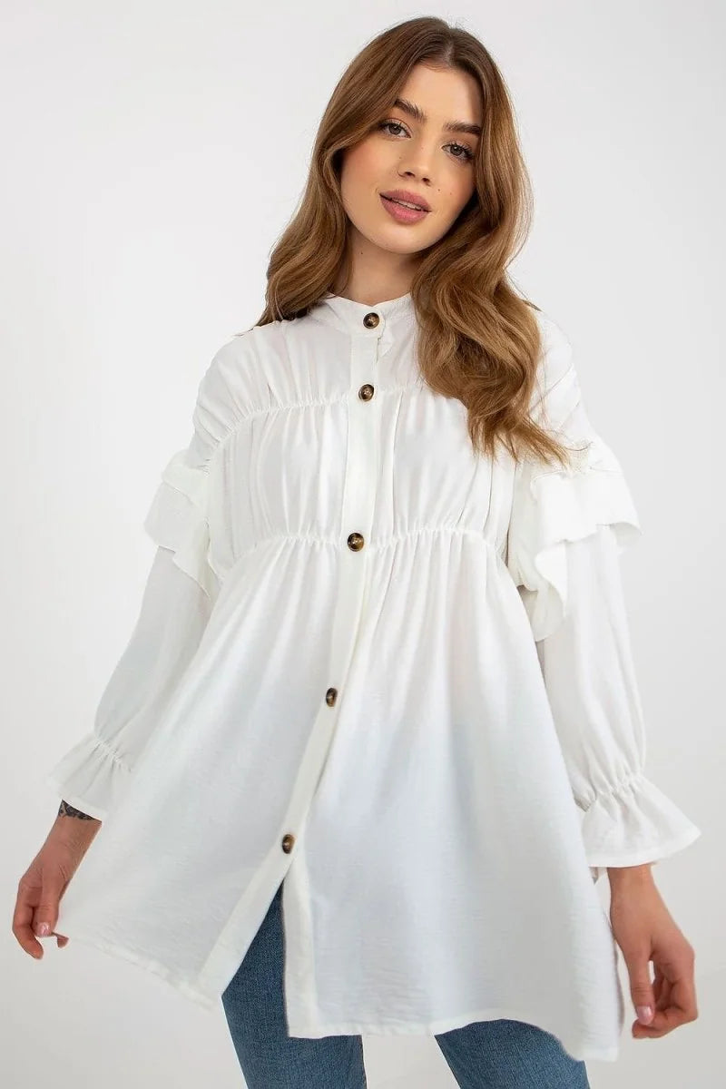 White ruffled button-up tunic with long sleeves on a model.