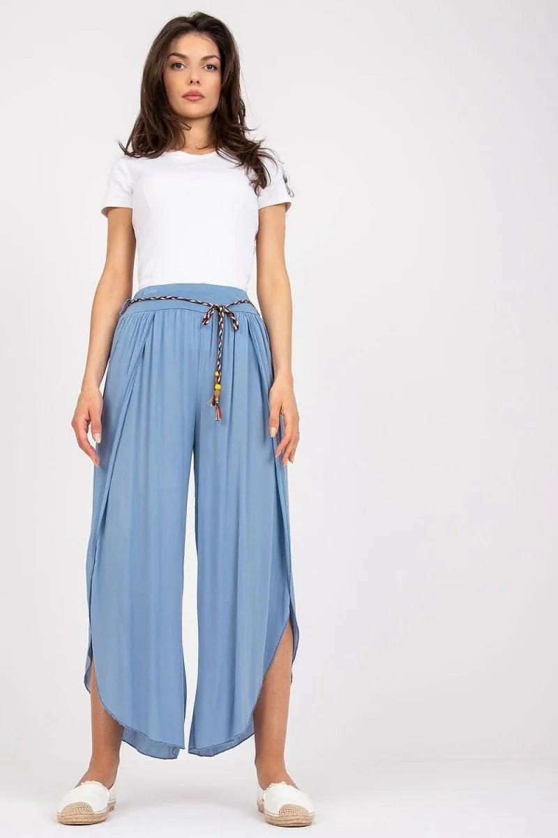 Light blue wide-leg viscose pants with decorative tie belt on a model.
