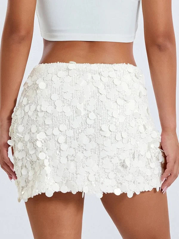 White sequined mini skirt with a ruffled hem, showing texture and sparkle.