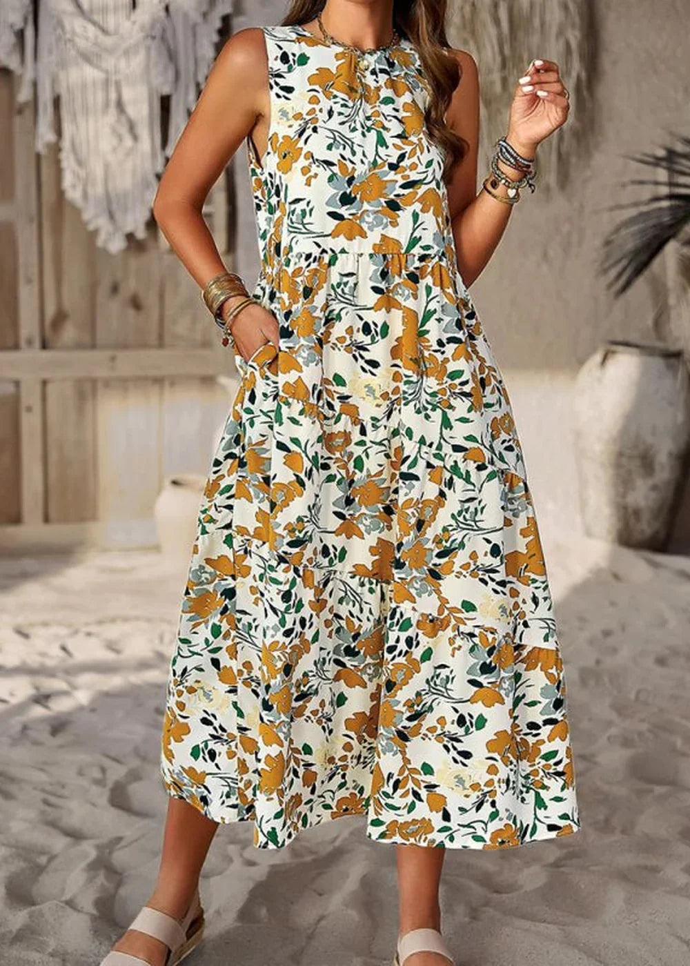 White sleeveless midi dress with a yellow and green floral print, featuring pockets.