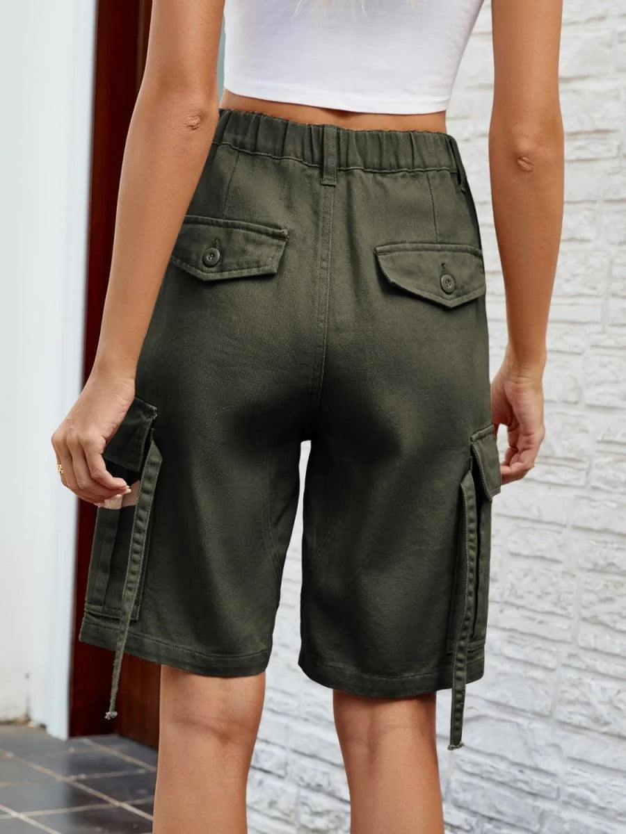 Back view of olive green cargo shorts with button flap pockets and drawstring details.