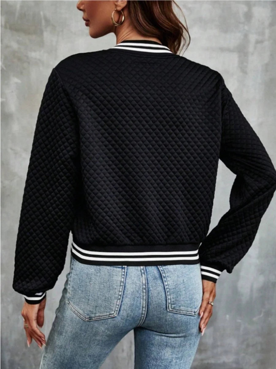 Black quilted bomber jacket with white striped cuffs and collar, shown from the back on a model.