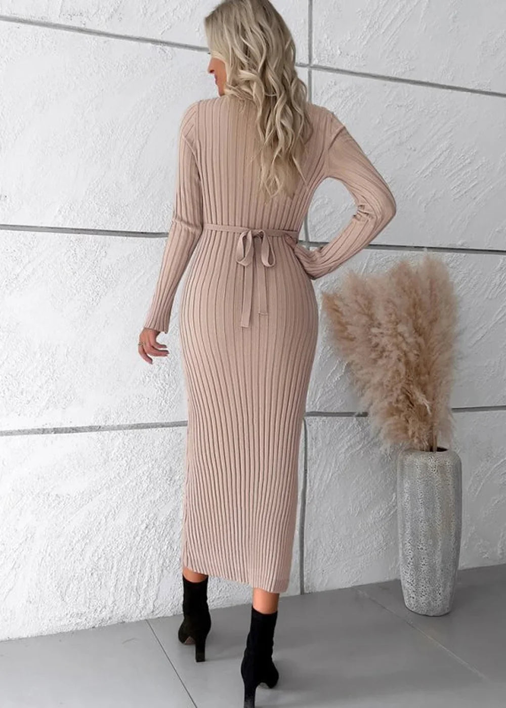 Beige ribbed knit midi dress with long sleeves and a tie waist, shown from the back.