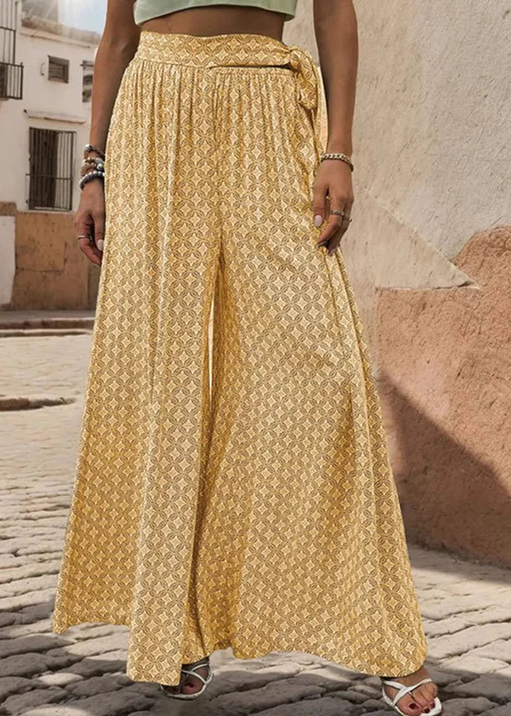 Yellow wide-leg pants with a geometric pattern and tie waist.