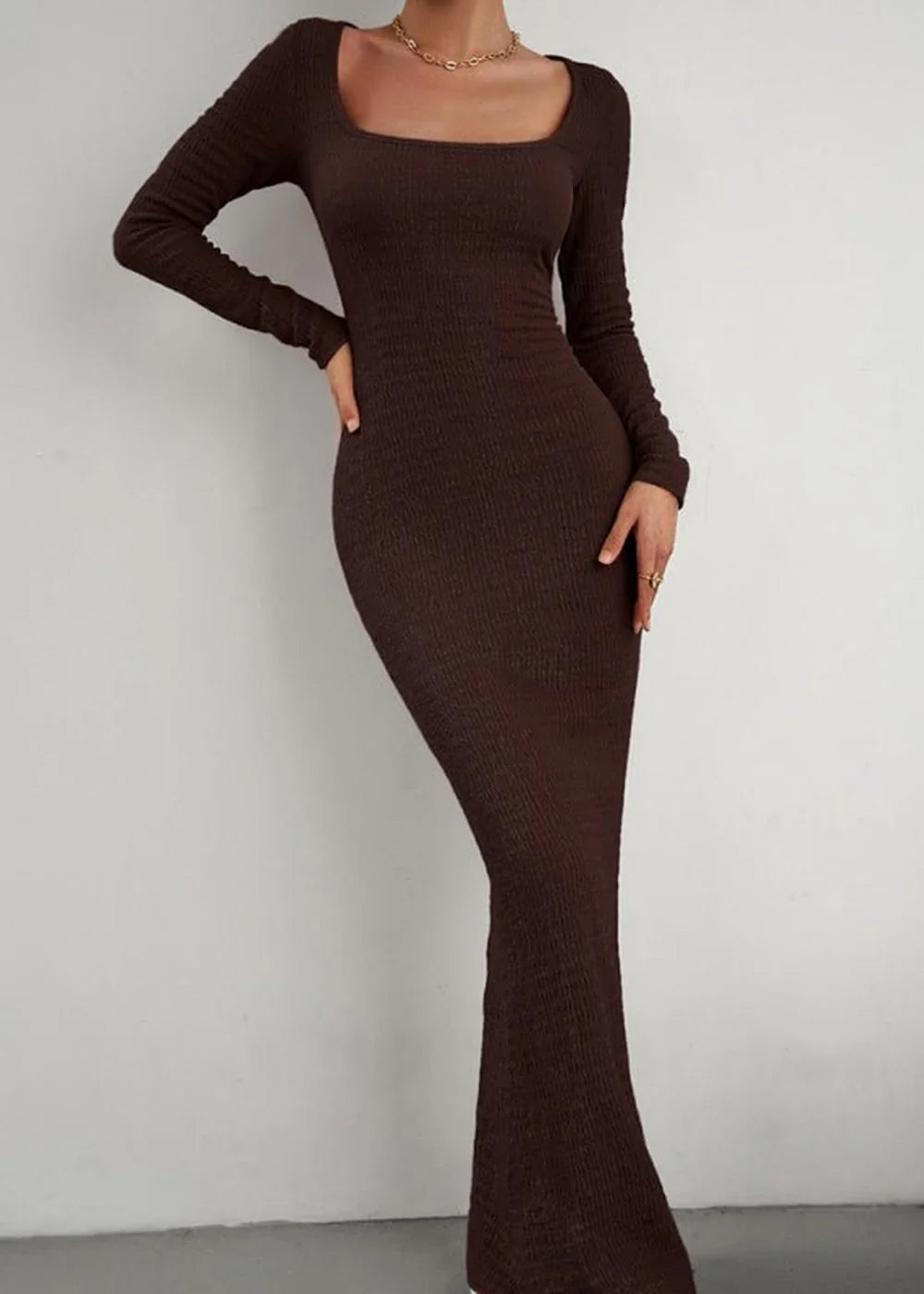 Brown ribbed knit maxi dress with square neckline and long sleeves, fitted on model.