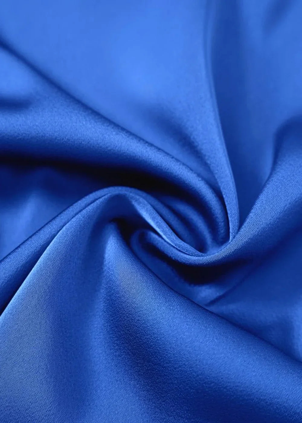 Close-up of royal blue satin fabric with soft folds and a subtle sheen.