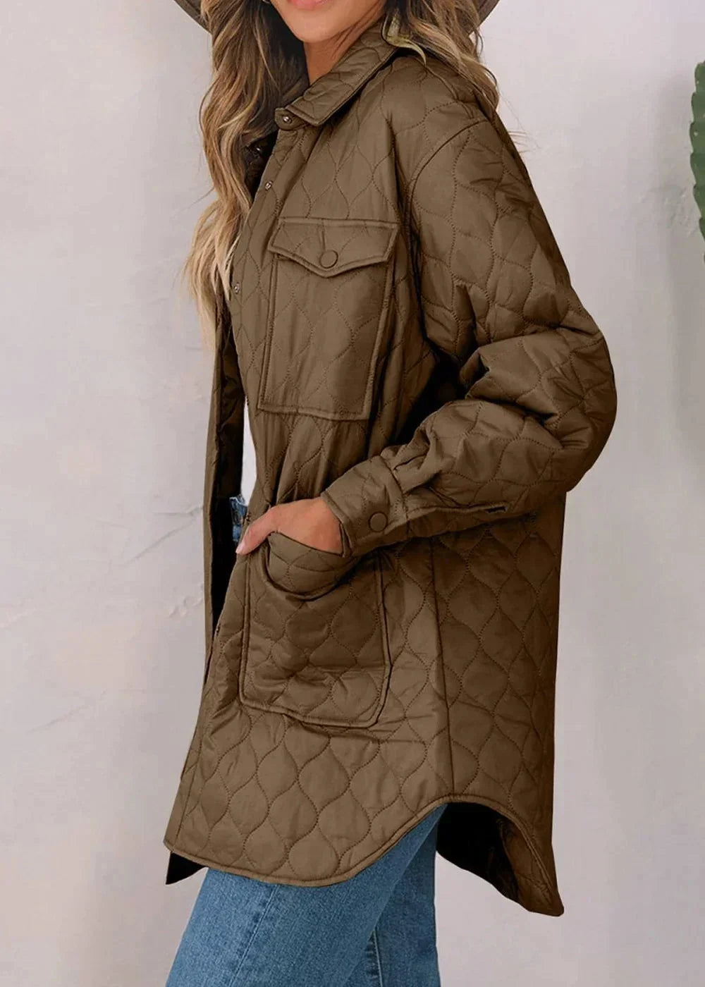 Quilted brown nylon shirt jacket with button pockets and a regular fit on a model.