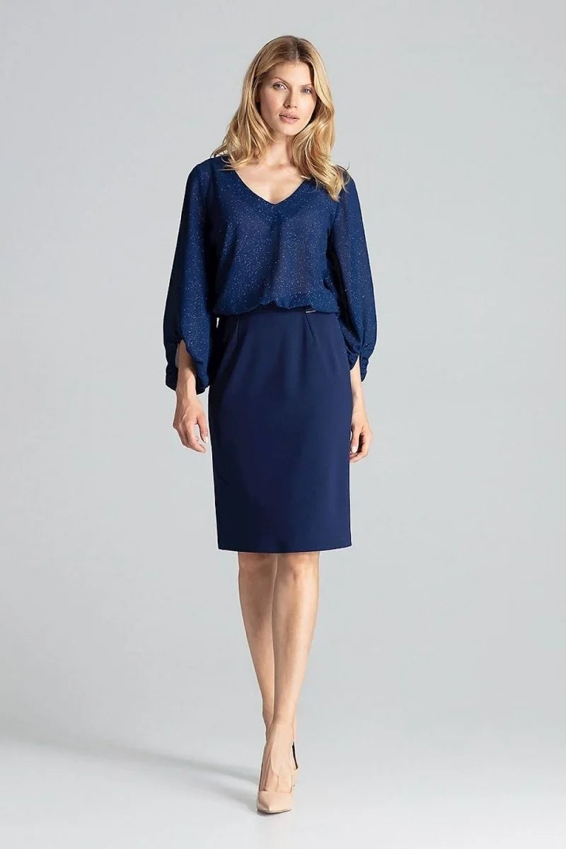Navy blue pencil skirt with a subtle sheen on a model, paired with a shimmering navy blue blouse.