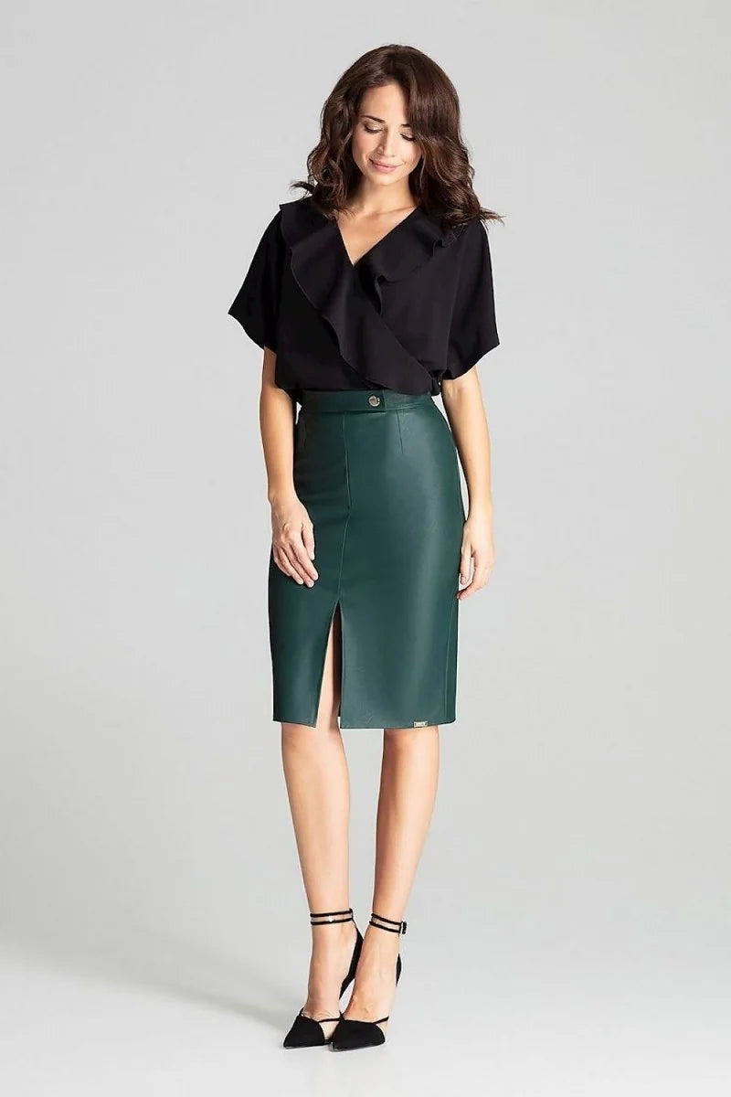 A woman models a sleek, dark green faux leather pencil skirt with a high slit and a matching button detail at the waist.