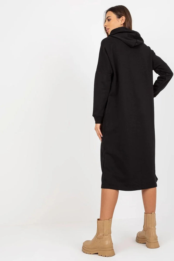 Black long hooded dress, relaxed fit, with tan chelsea boots.
