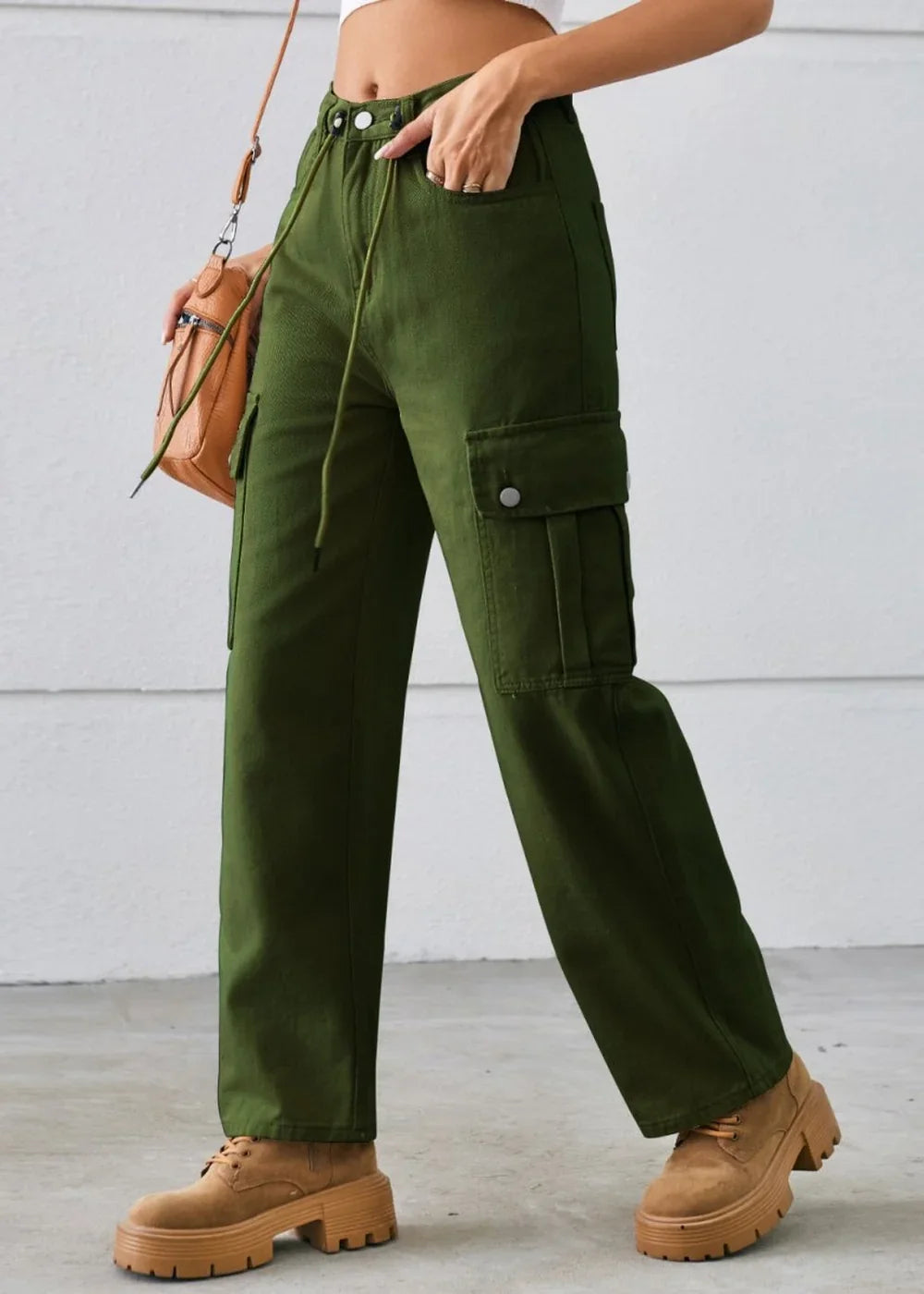 Green cargo pants with a drawstring waist and chunky tan platform shoes.