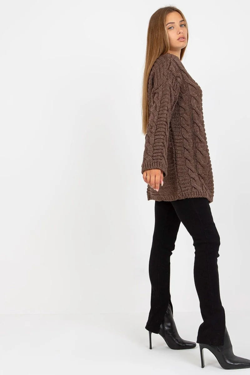 Brown cable-knit sweater on model with black pants and black heeled boots.