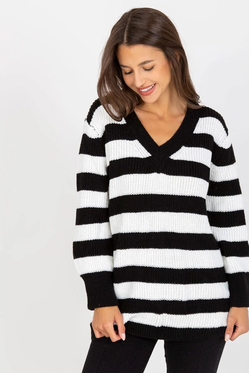 Black and white striped loose-fit sweater with a V-neck on a model.