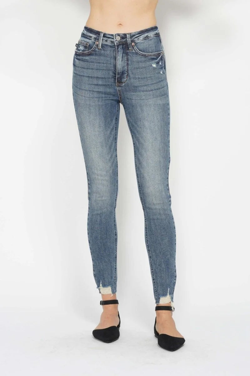 Medium wash high-waisted skinny jeans with a frayed hem.