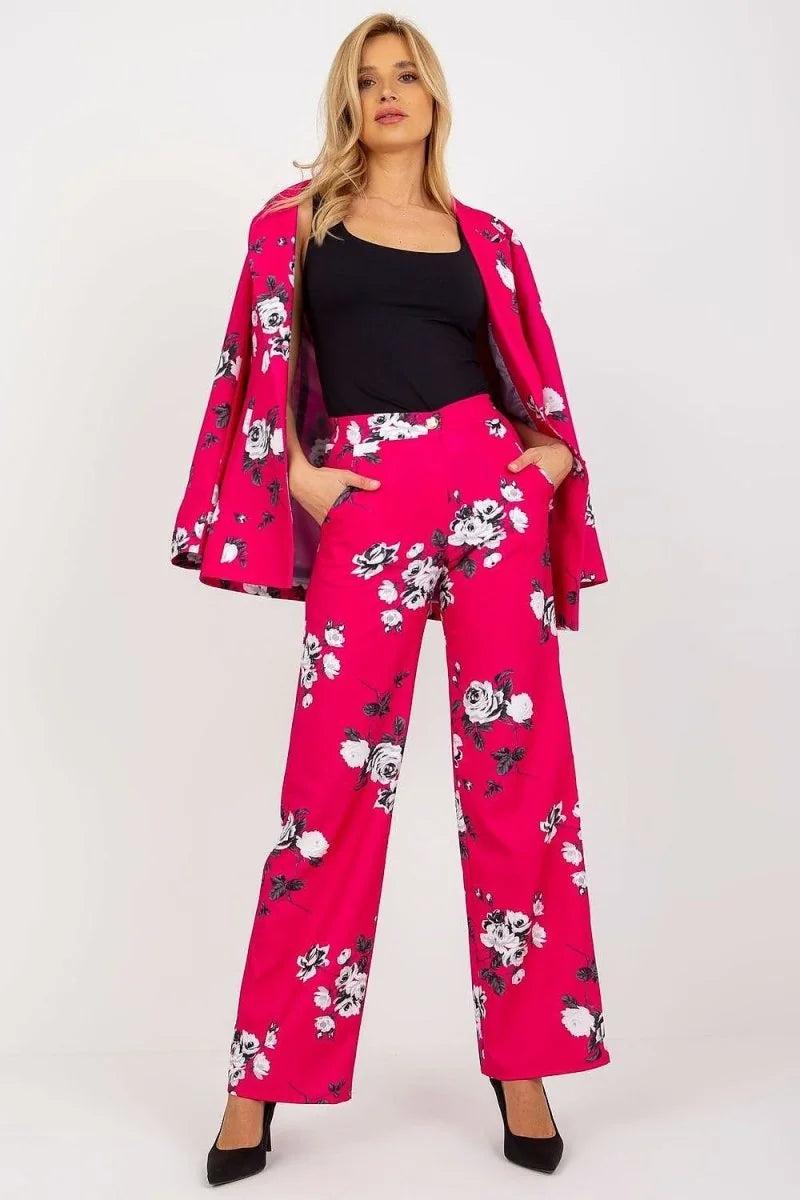 Women's bright pink wide-leg pants with a white and black floral print, featuring a regular fit and pockets.