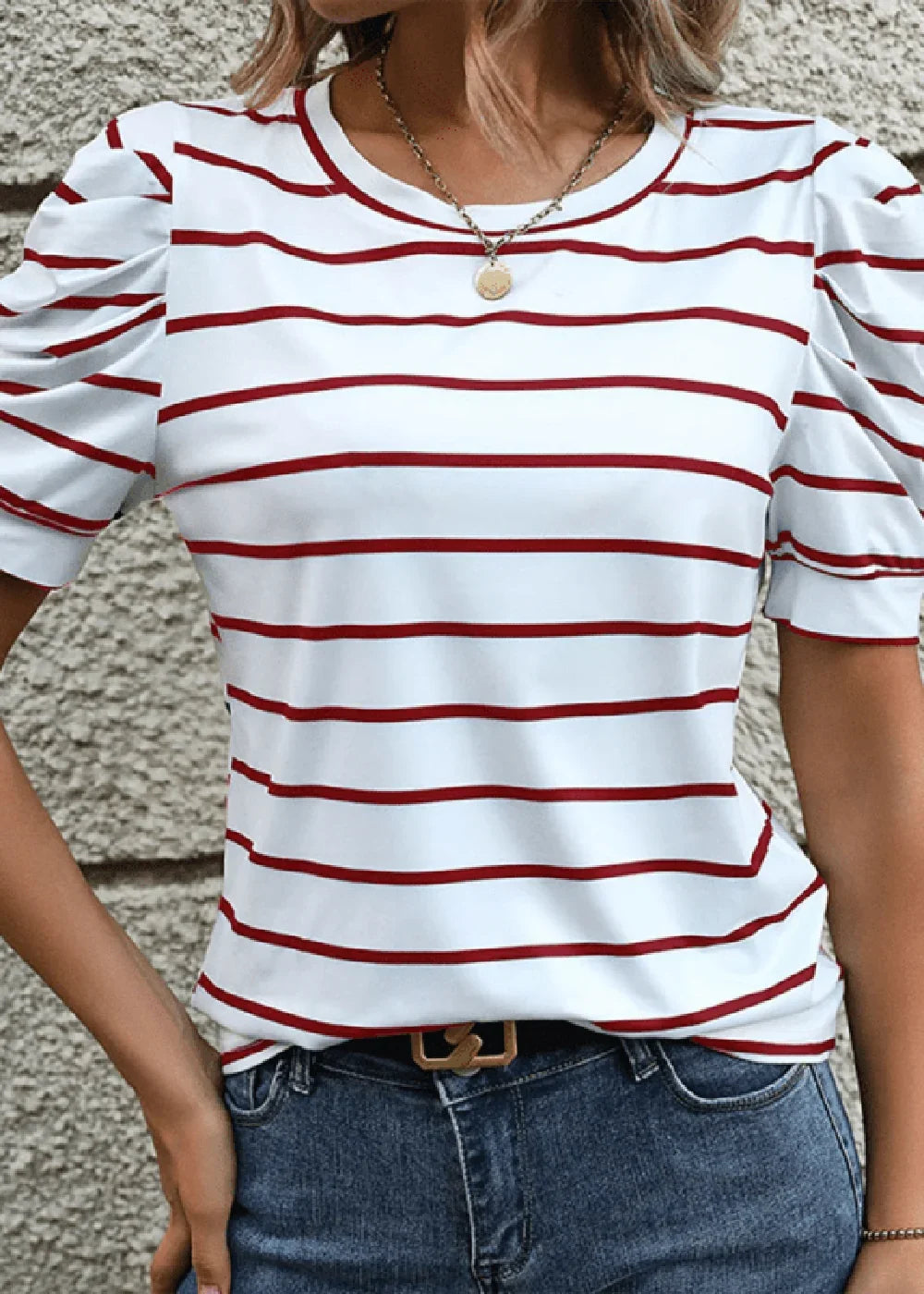 White and red striped top with puff sleeves and a gold pendant necklace.