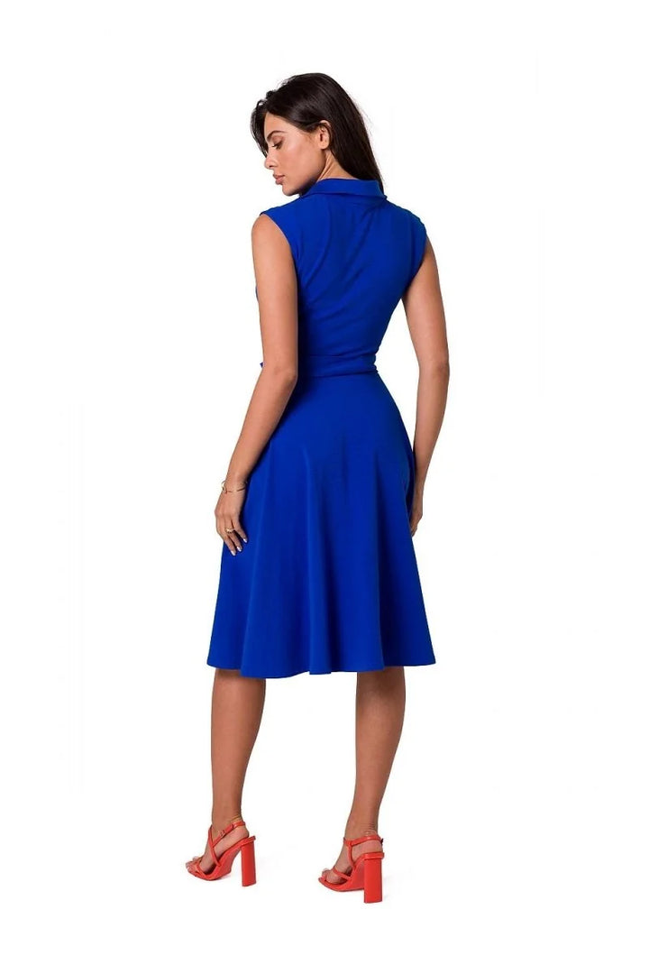 Royal blue sleeveless belted dress with a flared skirt, worn with orange block heels.