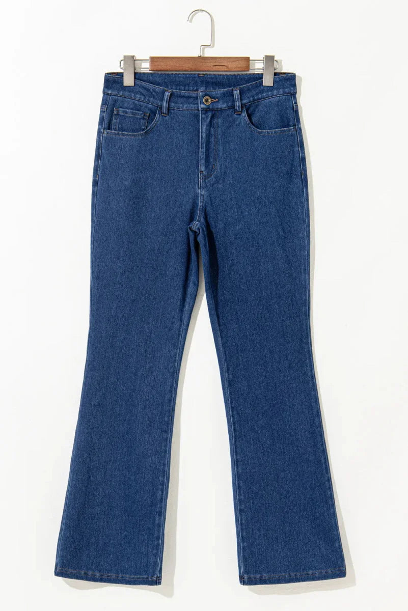 Dark blue denim jeans with a slight flare, showing texture and front pockets.