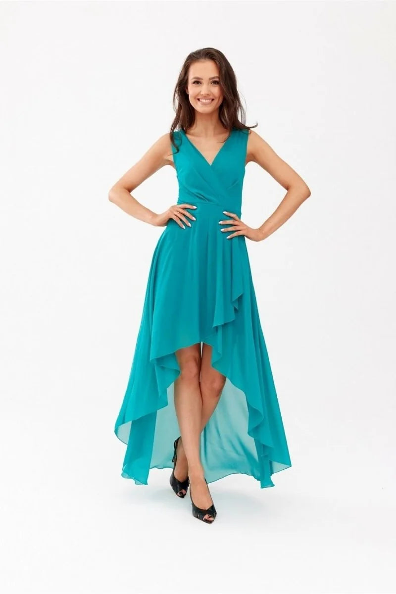 Teal high-low dress with a V-neck and ruffled hem, worn by a model on a white background.