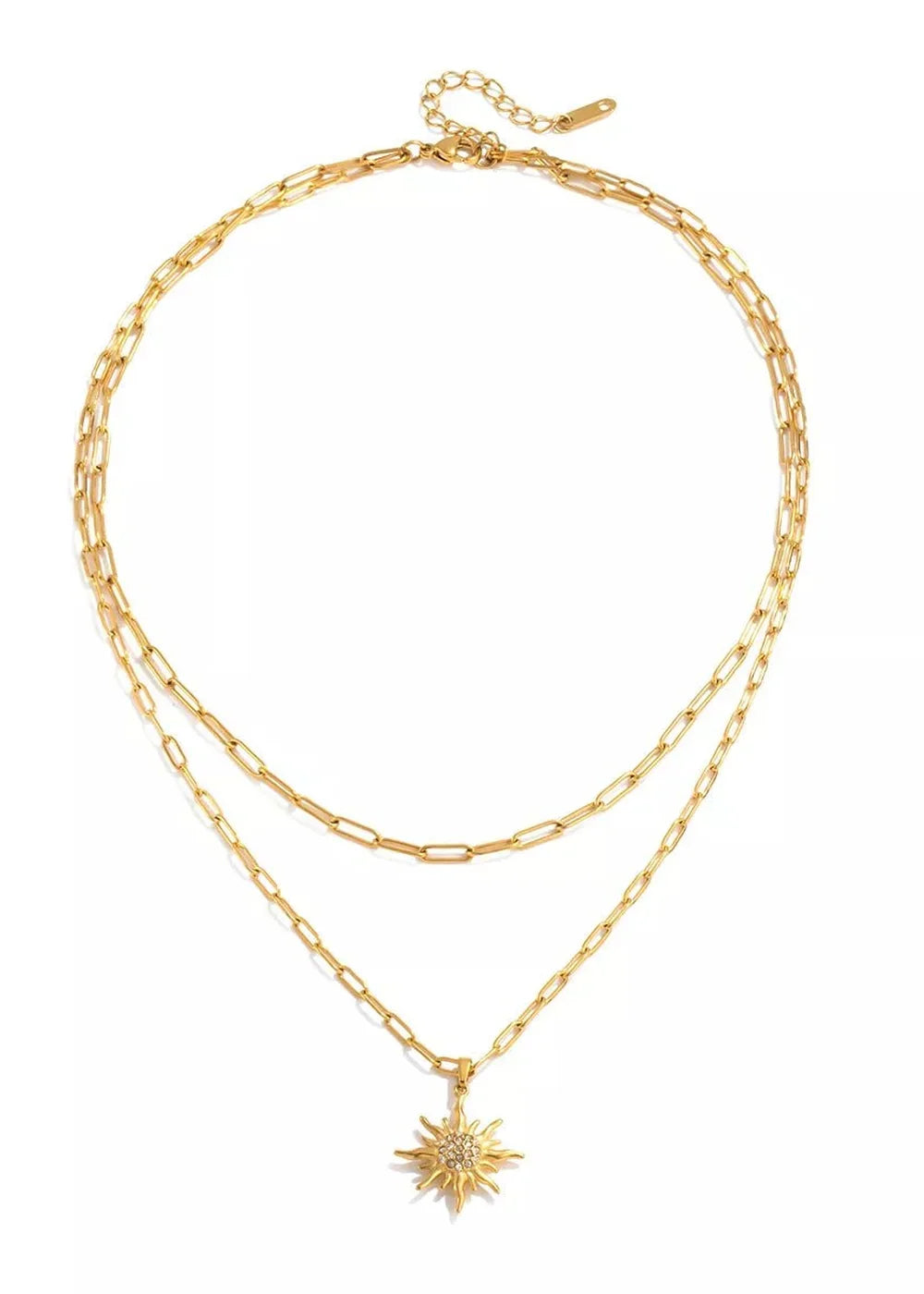 Gold layered necklace with a sparkling sun pendant, on a white background.