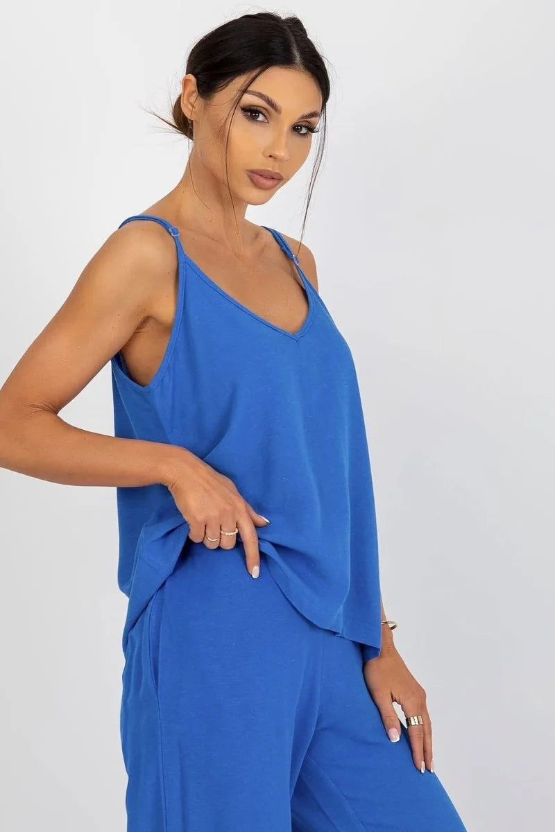 Loose-fitting blue cami with adjustable straps and v-neck, paired with matching pants.