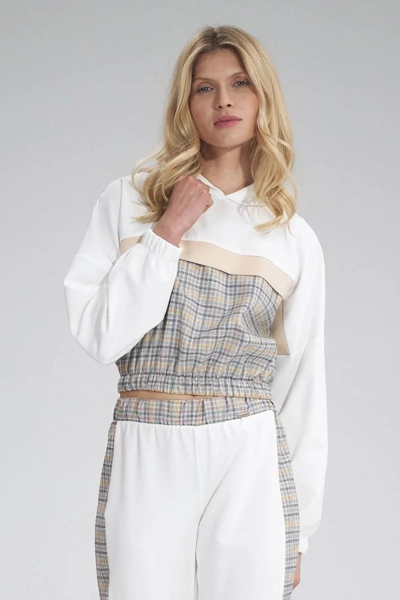 White and beige cropped hoodie with plaid pattern detail at the waist on model.