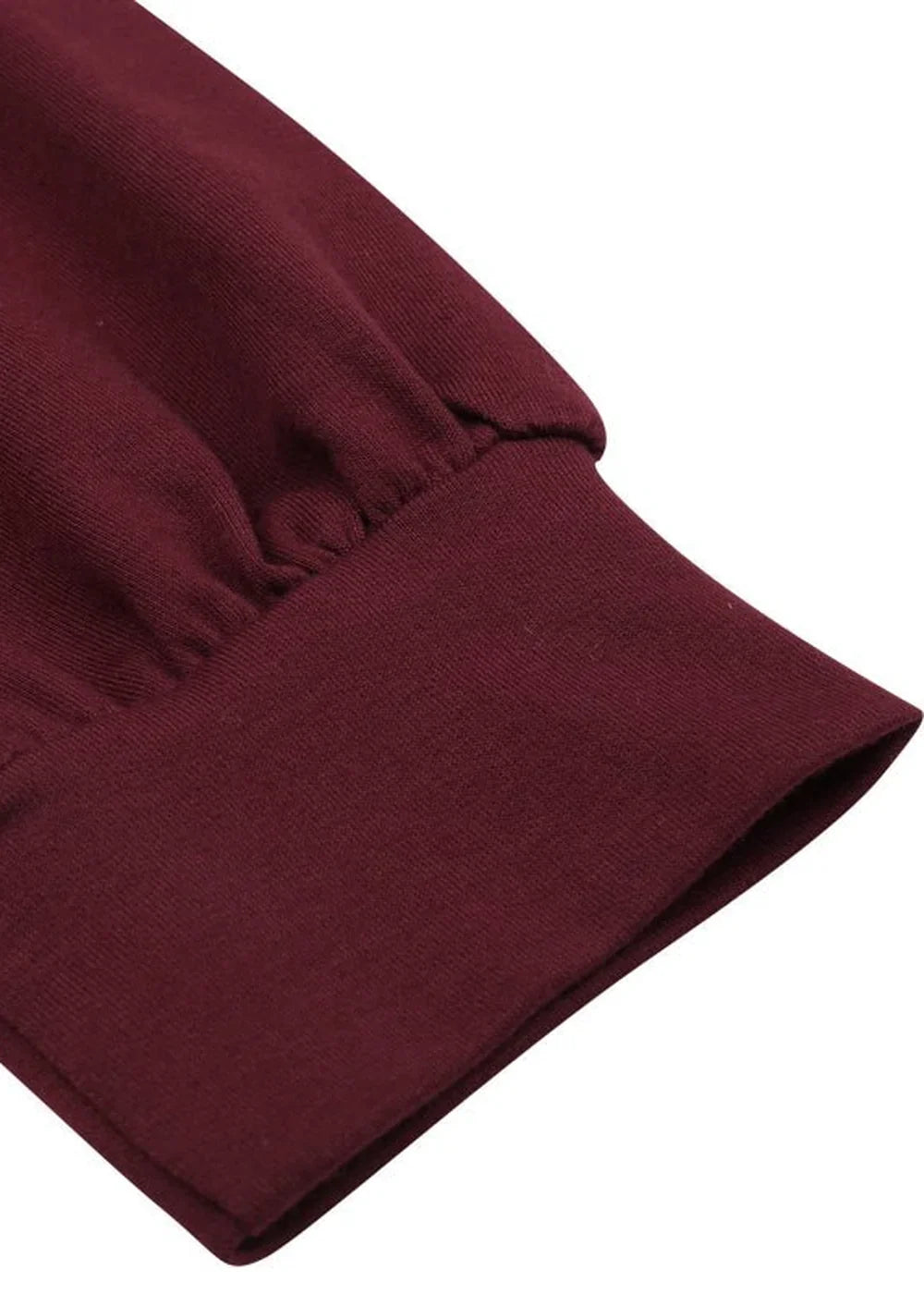 Close-up of maroon long sleeve cuff with ribbed texture.