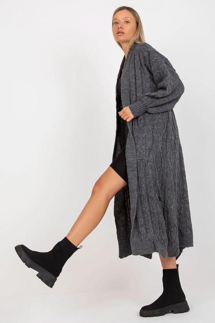 Gray cable knit long cardigan with relaxed silhouette on model, showing textured fabric.
