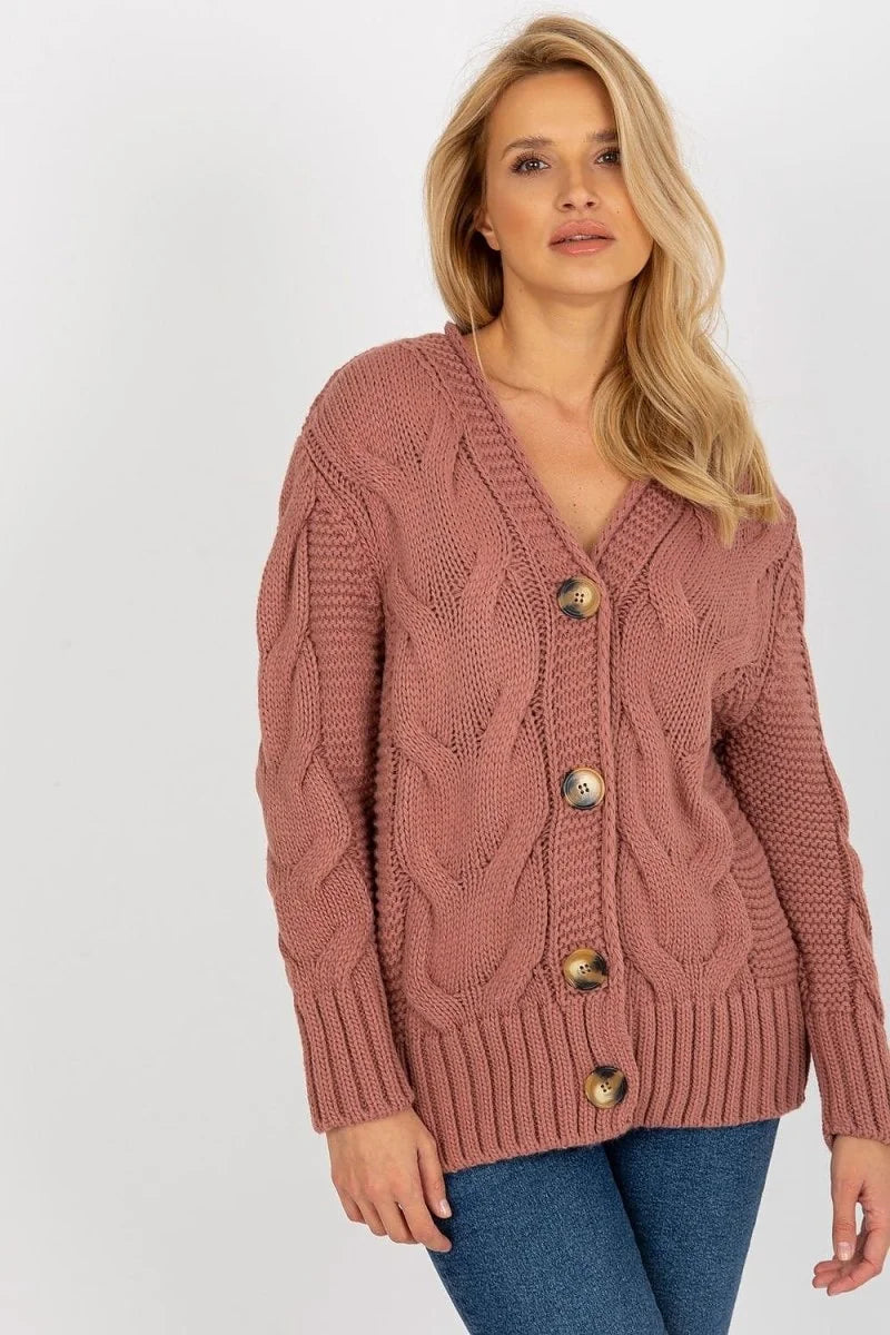Rose pink chunky cable knit cardigan with V-neck and brown buttons, on model.