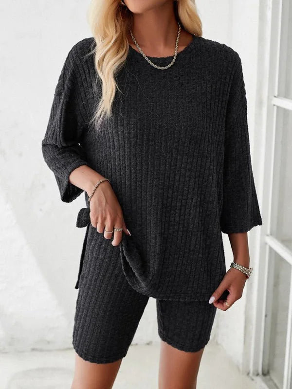 Charcoal ribbed knit short suit with a relaxed fit top and biker shorts, worn by a model.